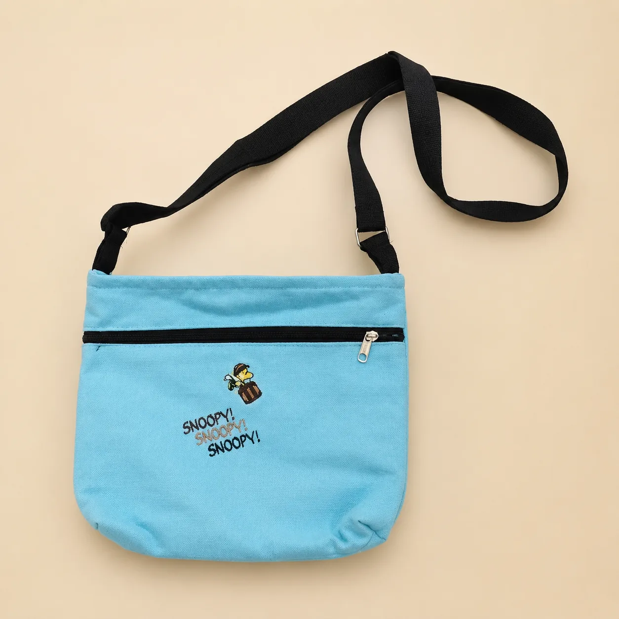 Premium blue cotton printed sling bag with adjustable black strap and zipper pocket
